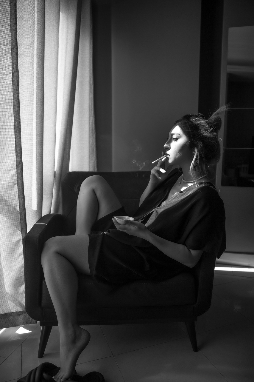 Editorial black-and-white portrait of a woman lit by window light